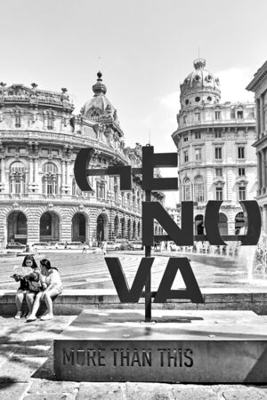 Genoa , Italy - July 7, 2019: Genova - More Than This sign (City Logo) and tourists in De Ferrari square in Genoa. Black and white imageのeditorial素材