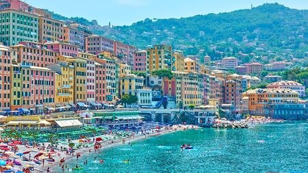 Camogli, Genoa, Italy - July 3, 2019:  Beach with resting people and waterfront colorful buildings in Camogli on sunny summer day, Liguriaのeditorial素材
