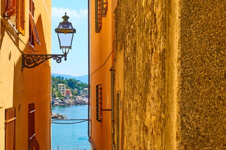Old street with old street light by the sea in Bogliasco town near Genoa, Italy. Copyspace compositionの写真素材