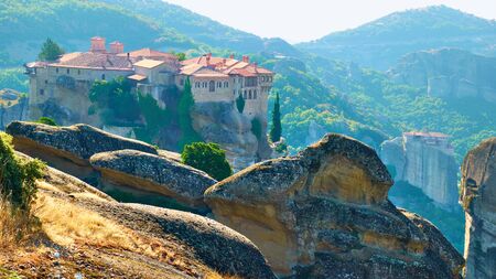 Panoramic view of Meteora with Varlaam monastery on the top of rock in the morning, Greece -  Greek...