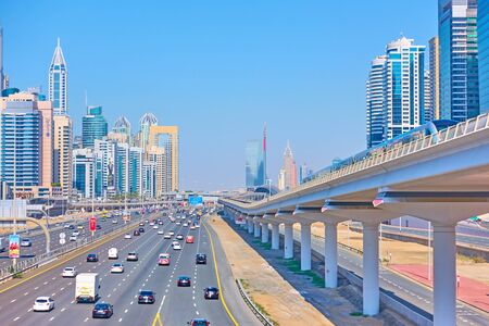 Dubai, OAE - January 30, 2020:  Perspective of Sheikh Zayed Road with modern skyscrapers and metro...