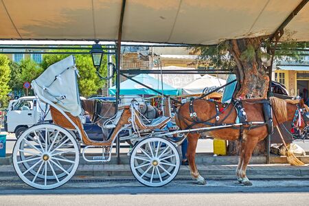 Aegina, Greece - September 16, 2019: Horse carriage at waterfront in Aegina townのeditorial素材