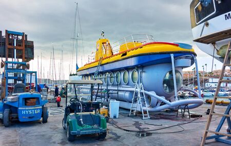 Tenerife,  Spain - December 12, 2019: Touristic submarine under repair on the shore inTenerifeのeditorial素材