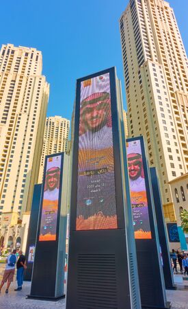 Dubai, UAE - January 30, 2020: Modern residential towers of Dubai Marina and advertising screens, United Arab Emiratesのeditorial素材