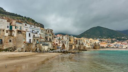 Picturesque old houses by the sea in Cefalu, Sicily, Italyの写真素材