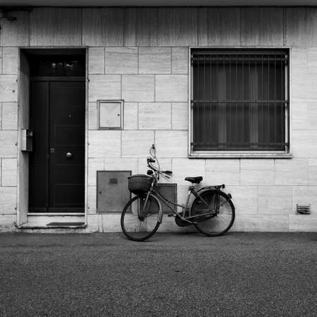 House and a bicycle near by. Black and white urban photography. Rimini, Italy.の写真素材