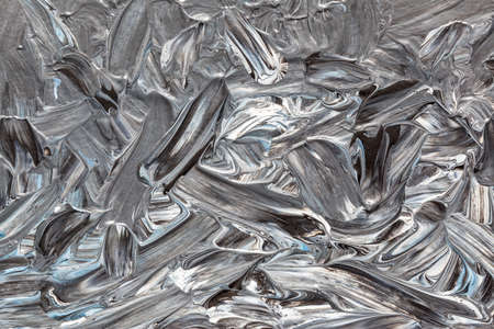 Chaotic brush strokes of oil paint.  Grey abstract background. Dark painted textureの写真素材