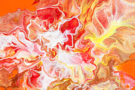 Freakish colorful stains of liquid paint. Orange fluid art abstract backgroundの写真素材