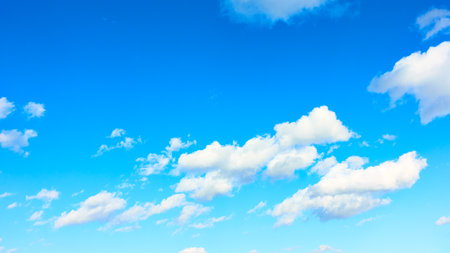 Panoramic view of blue sky with white clouds, may be used as backgroundの写真素材