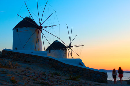 Windmills by the sea in Mykonos island at dusk, Greece. Greek rural landscapeの写真素材