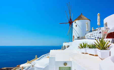 Greece, Santorini island. Greek landscape with old windmill in Oia villageの写真素材