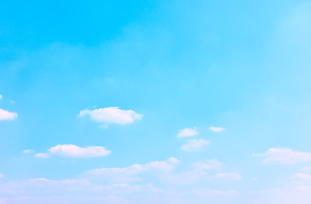 Light blue sky with rare white clouds - background with space for your own textの写真素材