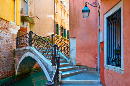 Canal with picturesque small bridge in Venice. Italy. Venetian cityscape, italian architectureの写真素材