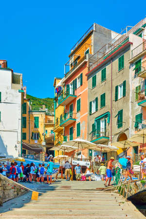Riomaggiore, La Spezia, Italy - July 2, 2019: Street by the sea  in Riomaggiore with walking people, Cinque Terreのeditorial素材