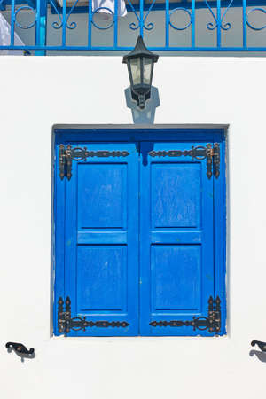 Greek whitewashed house with trditional blue shutters in Mykonos island, Greece. Architectural detailの写真素材