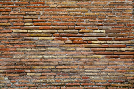 Ancient brickwork of flat roman bricks, Italy. May be used as backgroundの写真素材