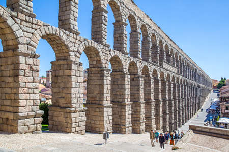 Segovia, Spain - September 21, 2015: Ancient roman aqueduct in Segovia and walking touristsのeditorial素材
