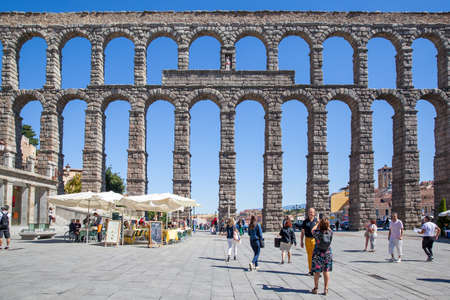 Segovia, Spain - September 21, 2015: Roman aqueduct in Segovia and walking people in Plaza Azoguejoのeditorial素材