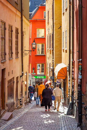 Stockholm, Sweden -  May 21, 2015: Narrow street with walking people in Gamla Stan (Old Town) in Stockholmのeditorial素材