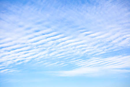 White clouds with wavy texture in the blue skyの写真素材
