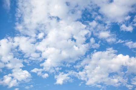 White fluffy clouds in the blue sky - natural backgroundの写真素材