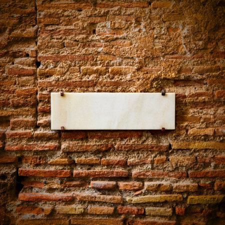 Blank marble plate on the ancient brick wallの写真素材