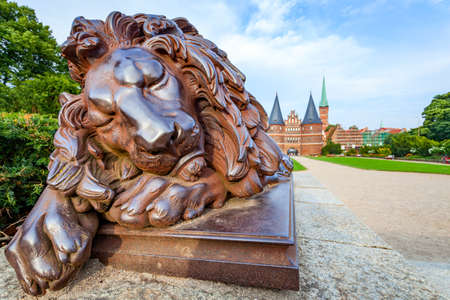 Statue Of Sleeping Lion ( 1823, Attributed to Christian Daniel Rauch ) near Holsten Gate in Lubeck, Germanyの写真素材