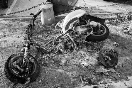 Burnt out motor scooter close-up. Black and white photographyの写真素材