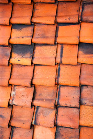 Old red clay roof tiles close up, may be used as backgroundの写真素材