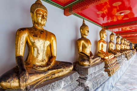 Gilt statues of the Buddha in buddhist temple in Bangkok, Thailandの写真素材