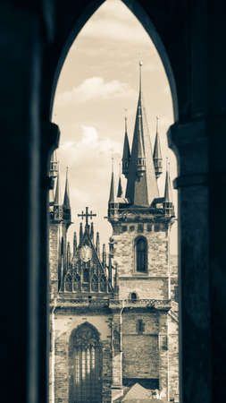 Church of Our Lady before Tyn in Prague through gothic window of the Old Town Hall, Czech Republic. Black and white photography, sepia tonedの写真素材