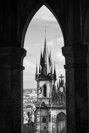 Tyn Church in Prague through gothic ogive window of the Old Town Hall, Czech Republic. Black and white cityscapeの写真素材