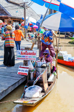 Pattaya, Thailand - December 6, 2009: Vendor in wooden boat at Pattaya Floating Marketのeditorial素材