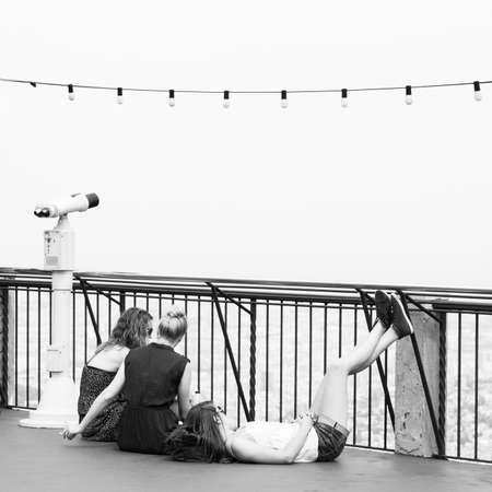 Tibidabo, Barcelona, Spain - June 12, 2011: Young girls resting at Tibidabo viewing point. Black and white urban photographyのeditorial素材