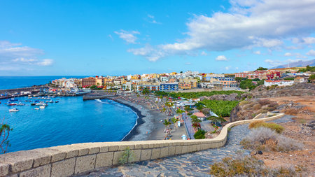 Playa San Juan, Guia de Isora, Spain - December 8, 2019:  Promenade by the ocean and beach in Playa...