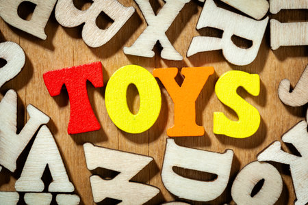 Word 'Toys' by color wooden letters close up