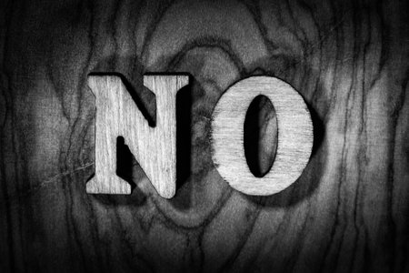 'No' word - Inscription by wooden letters close up. Black and white image