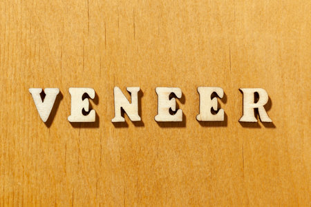 Word 'Veneer' by wooden letters close upの写真素材