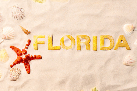 Florida - Text in white sand with seashells and starfish. Beach vacation conceptの写真素材