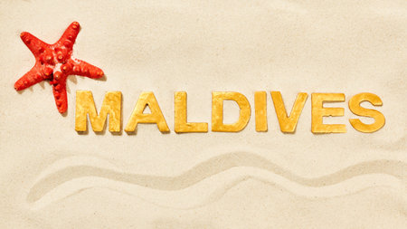 Maldives - Word by golden letters in white sandの写真素材