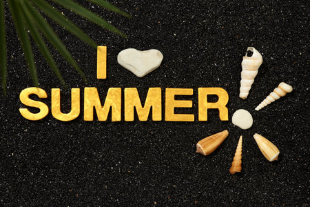 I Love Summer - Text in black beach sand with shells and sea pebblesの写真素材