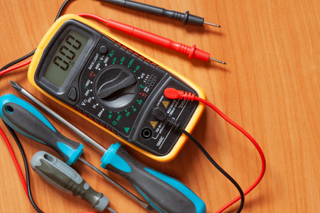 Digital multimeter and screwdrivers on table. Maintenance and repair conceptの写真素材