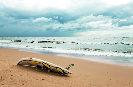 Board for windsurfing on the beach and cloudy skyの写真素材