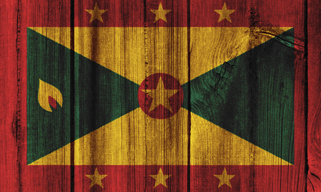 Grenada  flag painted on wooden wall for background.の写真素材