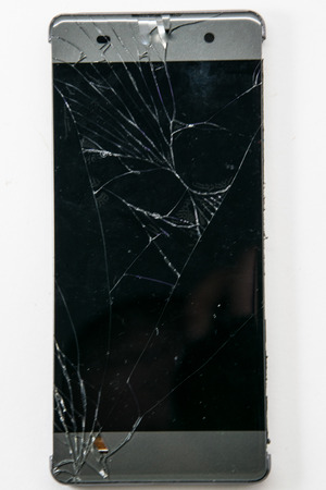 Smartphone with broken screen isolated on white background.の写真素材