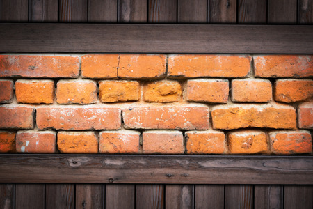Old grunge brick wall on wooden background.の写真素材
