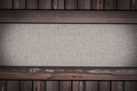 brown fabric texture closeup on wooden background.の写真素材