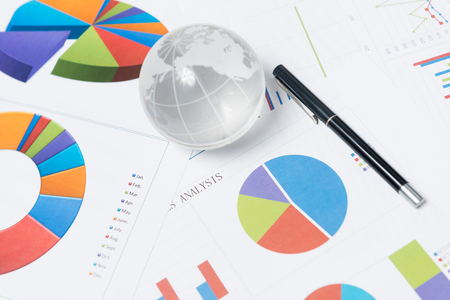 Business presentation with globe and chart on the deskの写真素材