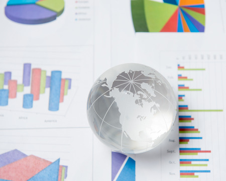 Business presentation with glboe and chart on the deskの写真素材