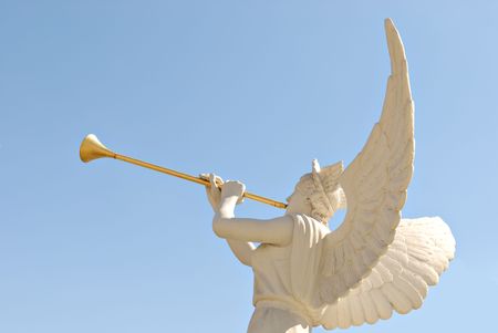 The statue of the angel with golden trumpetの写真素材